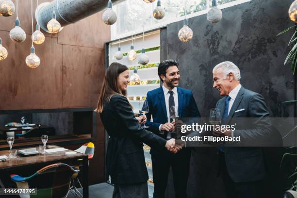 business meeting in a restaurant - happy hour stock pictures, royalty-free photos & images