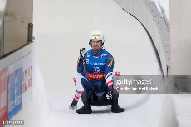 Thomas Steu and Lorenz Koller of Austria react after crossing the finish line of the men's double race during the FIL Luge World Cup at...