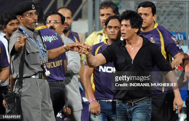 Bollywood actor and Indian Premier League franchise Kolkata Knight Riders co-owner Shah Rukh Khan gestures towards a security guard blowing a whistle...