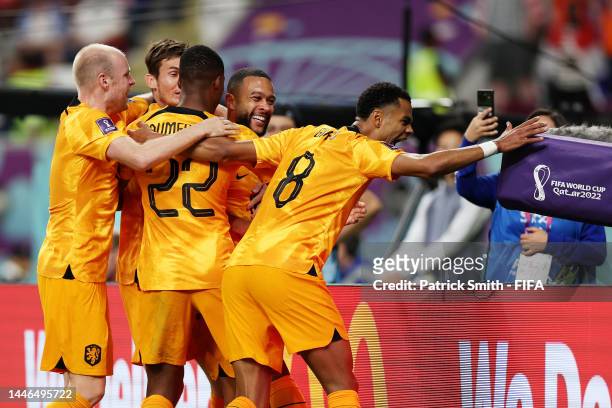 Memphis Depay of Netherlands celebrates with teammates after scoring the team's first goal during the FIFA World Cup Qatar 2022 Round of 16 match...