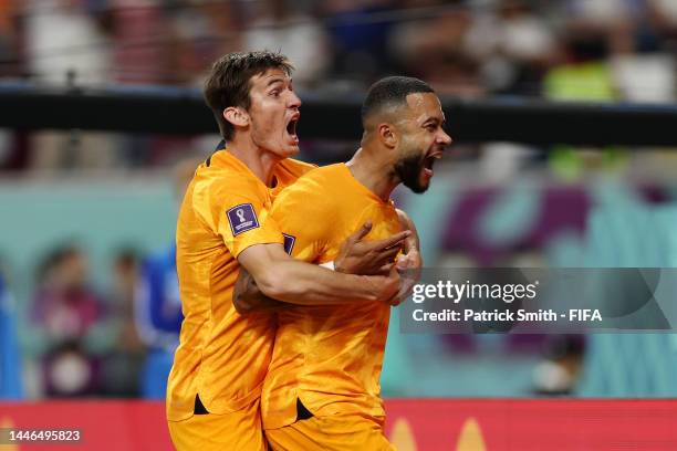 Memphis Depay of Netherlands celebrates after scoring the team's first goal with teammate Marten de Roon during the FIFA World Cup Qatar 2022 Round...