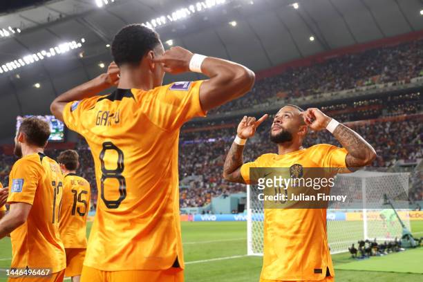 Memphis Depay of Netherlands celebrates after scoring the team's first goal with teammate Cody Gakpo during the FIFA World Cup Qatar 2022 Round of 16...