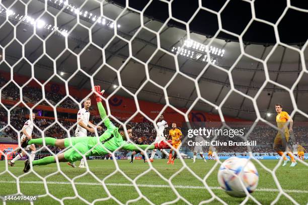Memphis Depay of Netherlands scores the team's first goal past Matt Turner of United States during the FIFA World Cup Qatar 2022 Round of 16 match...