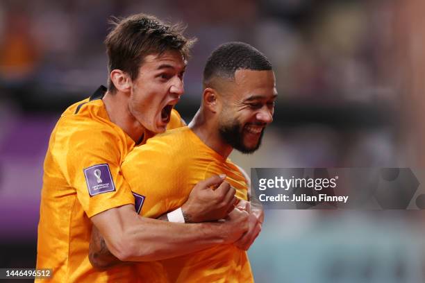 Memphis Depay of Netherlands celebrates after scoring the team's first goal with teammate Marten de Roon during the FIFA World Cup Qatar 2022 Round...