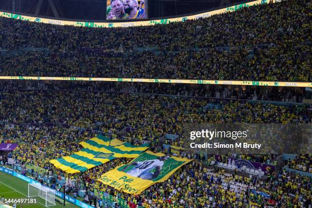 Giant banner displaying Get Well Soon Pele is held by the Brazil fans in the stands during the FIFA World Cup Qatar 2022 Group G match between...