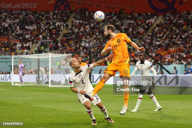 Daley Blind of Netherlands heads the ball against Sergino Dest of United States during the FIFA World Cup Qatar 2022 Round of 16 match between...