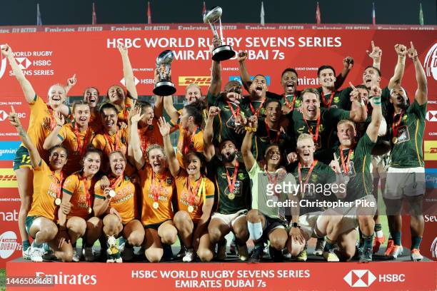 Players of Australia and South Africa celebrate victory during the Cup Final matches on Day Two of the HSBC World Rugby Sevens Series - Dubai at The...