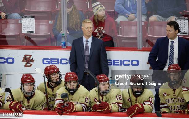 Head Coach Greg Brown of the Boston College Eagles stands behind the bench during a game against the Providence College Friars during NCAA hockey at...
