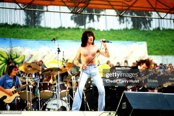 Bon Scott, is the front man for AC/DC.They are performing at a Day on the Green at the Oakland Coliseum in Oakland, California on July 21, 1979.