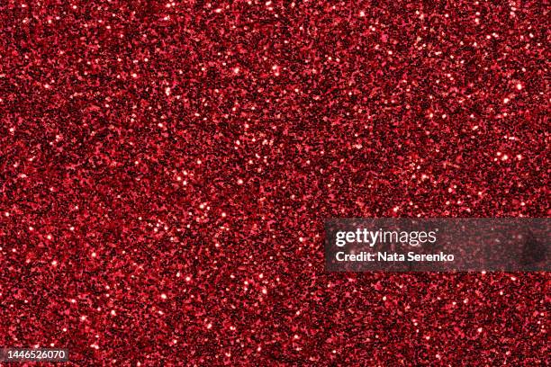 festive red macro glittering background. - red glitter stock-fotos und bilder