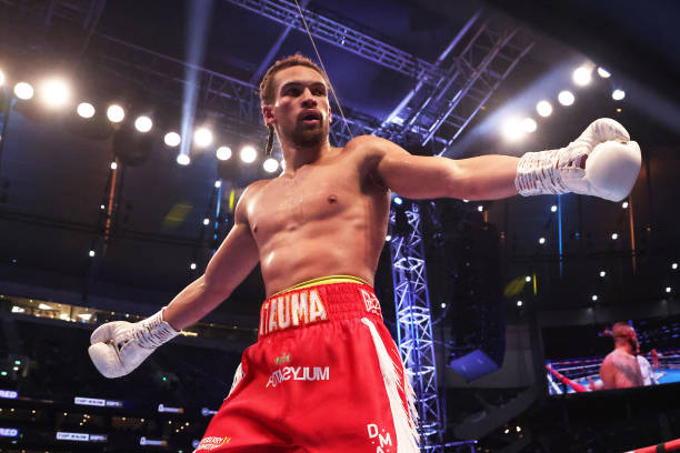 Karol Itauma celebrates victory after the Light Heavyweight fight between Karol Itauma and Vladimir Belujsky at Tottenham Hotspur Stadium on December...