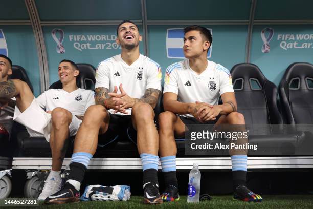 Leandro Paredes and Paulo Dybala of Argentina look on from the bench during the FIFA World Cup Qatar 2022 Round of 16 match between Argentina and...