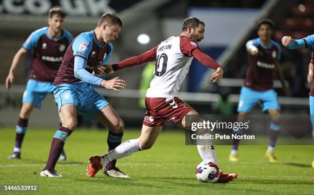 Danny Hylton of Northampton Town attempts to control the ball under pressure from Tom Davies of Tranmere Rovers during the Sky Bet League Two between...