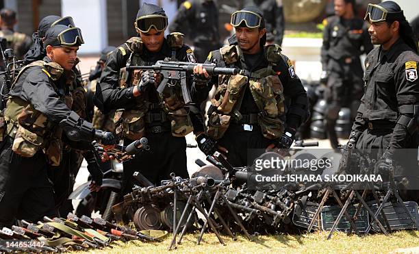 Sri Lankan army Special Force commandos interact during a Victory Day parade rehearsal in Colombo on May 17, 2012. Sri Lanka celebrates War Heroes...