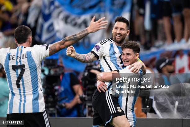 Julian Alvarez of Argentina celebrates with Lionel Messi and Rodrigo De Paul of Argentina after scoring his team's second goal during the FIFA World...