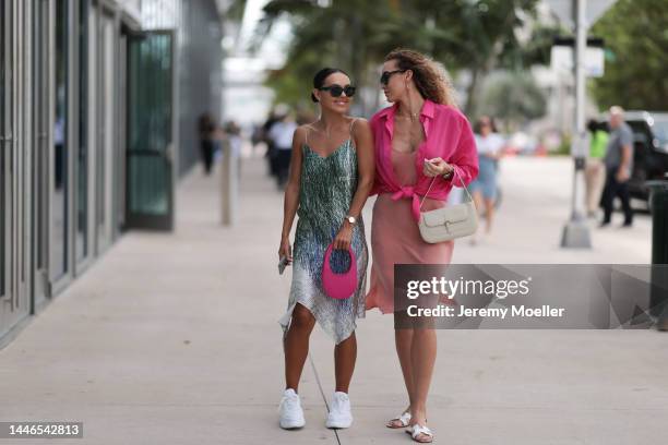 Marina Kuz seen wearing a pink Coperni bag, a dress by Off-White and Prada sneaker and Merz Marina seen wearing Hermès oran sandals and a beige dress...