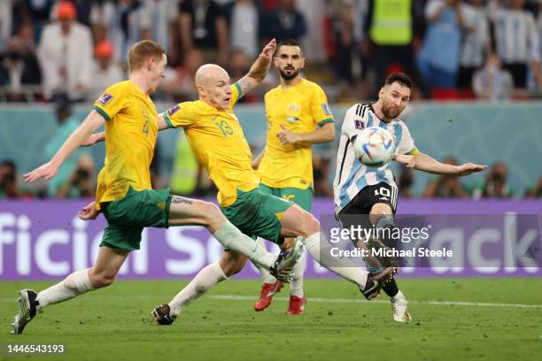 Lionel Messi of Argentina shoots the ball against Aaron Mooy of Australia during the FIFA World Cup Qatar 2022 Round of 16 match between Argentina...