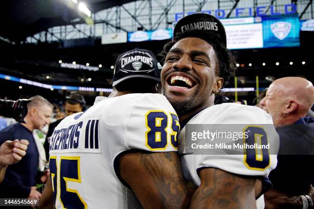 Demeer Blankemsee of the Toledo Rockets celebrates with Larry Stephens III after the Rockets defeated the Ohio Bobcats, 17-7, to win the MAC...