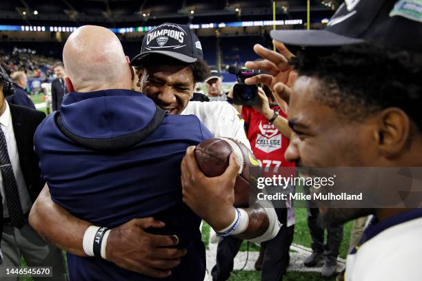 Dequan Finn of the Toledo Rockets hugs a member of the coaching staff after the Rockets defeated the Ohio Bobcats, 17-7, to win the MAC Championship...