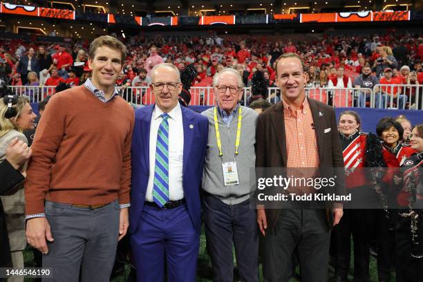 Former Football Quarterbacks Eli Manning , Archie Manning and Peyton Manning pose with SEC Commissioner Greg Sankey prior to the SEC Championship...