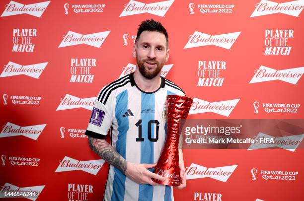 Lionel Messi of Argentina poses with the Budweiser Player of the Match Trophy following the FIFA World Cup Qatar 2022 Round of 16 match between...