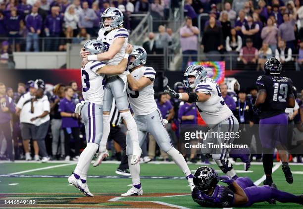 Kicker Ty Zentner of the Kansas State Wildcats celebrates with holder Jack Blumer after kicking the game winning field goal in overtime against the...