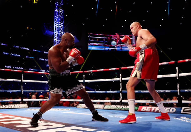 Tyson Fury punches Derek Chisora during the WBC World Heavyweight Title fight between Tyson Fury and Derek Chisora at Tottenham Hotspur Stadium on...