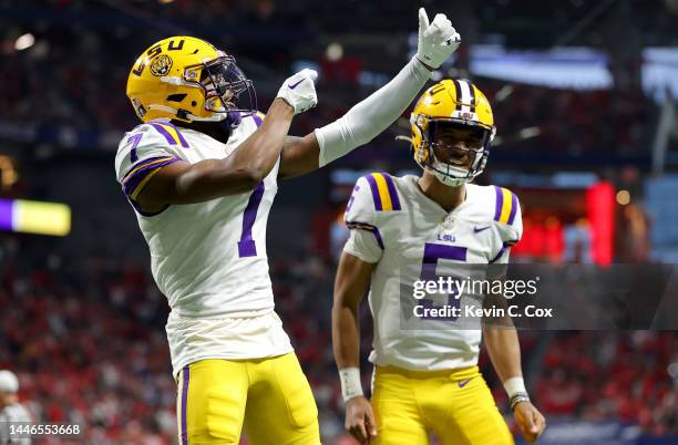 Kayshon Boutte of the LSU Tigers celebrates with Jayden Daniels after scoring a 53 yard touchdown against the Georgia Bulldogs during the first...