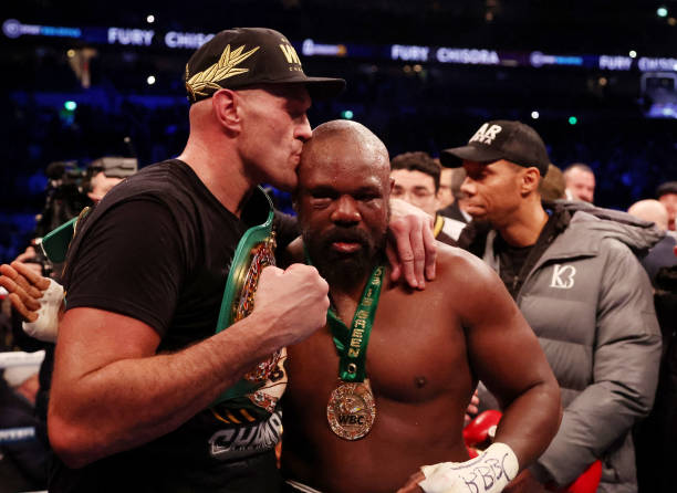 Tyson Fury interacts with Derek Chisora after victory in the WBC World Heavyweight Title fight between Tyson Fury and Derek Chisora at Tottenham...