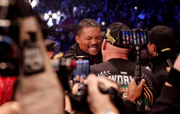 Tyson Fury interacts with Joe Joyce after the WBC World Heavyweight Title fight between Tyson Fury and Derek Chisora at Tottenham Hotspur Stadium on...
