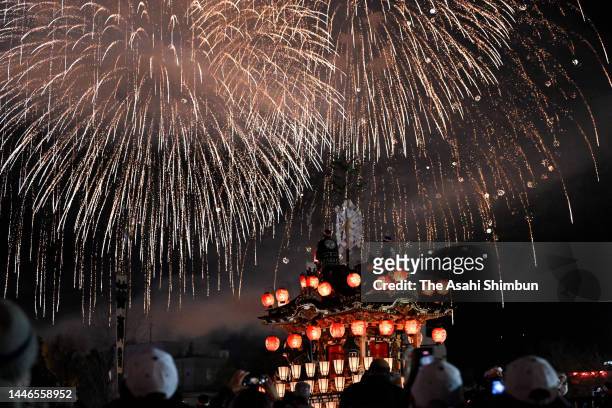 Fireworks explode above illuminated floats during the Chichibu Yomatsuri, or Chichibu Night Festival on December 3, 2022 in Chichibu, Saitama, Japan.