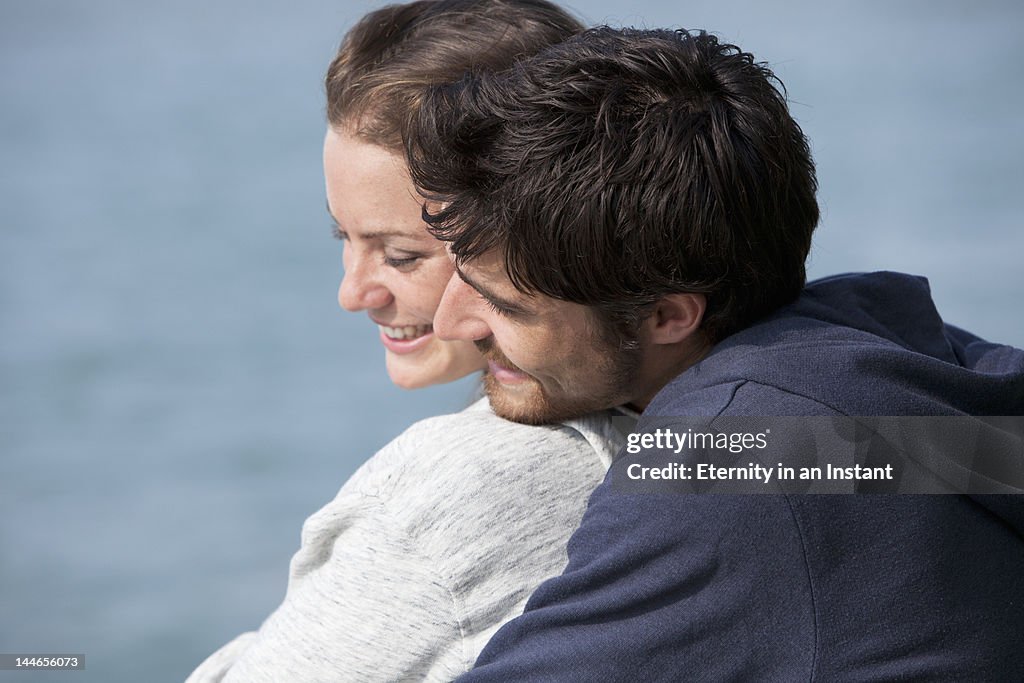 Young smiling couple hugging outdoors