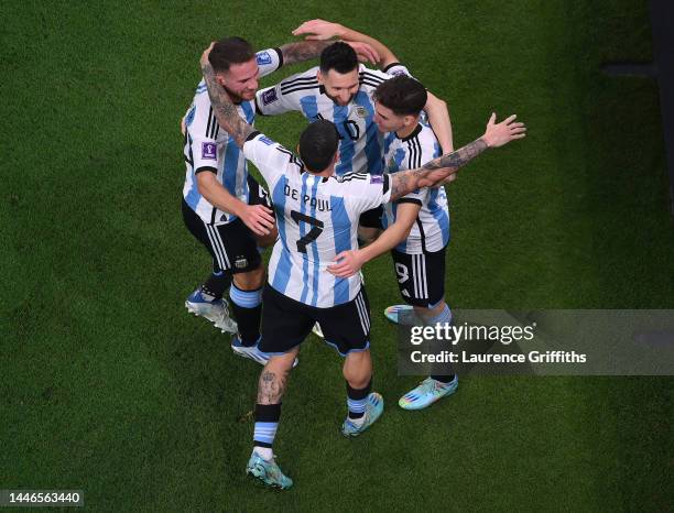 Julian Alvarez of Argentina is congratulated after scoring the second goal by Alexis Mac Allister, Lionel Messi, and Rodrigo De Paul during the FIFA...