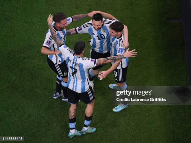 Julian Alvarez of Argentina is congratulated after scoring the second goal by Alexis Mac Allister, Lionel Messi, and Rodrigo De Paul during the FIFA...