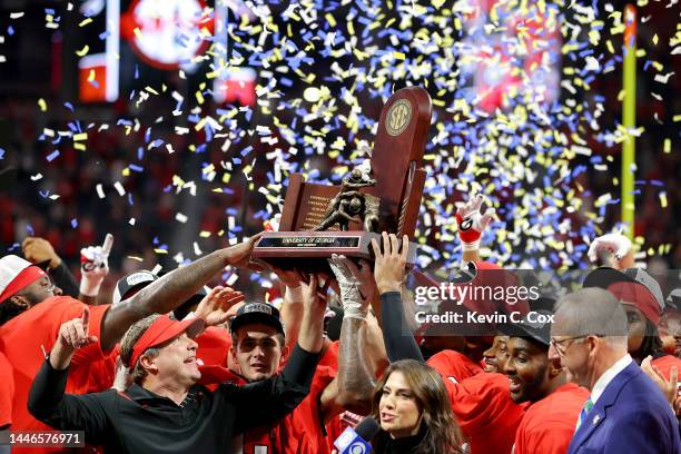 Head coach Kirby Smart and Stetson Bennett of the Georgia Bulldogs celebrate with the trophy after defeating the LSU Tigers in the SEC Championship...