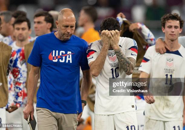 Christian Pulisic of USA is consoled by Head Coach Gregg Berhalter after defeat in the FIFA World Cup Qatar 2022 Round of 16 match between...