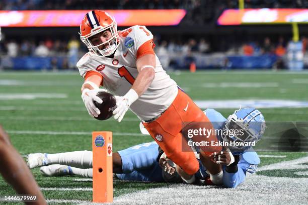 Will Shipley of the Clemson Tigers comes up just short of the end zone after being tackled by Power Echols of the North Carolina Tar Heels in the...