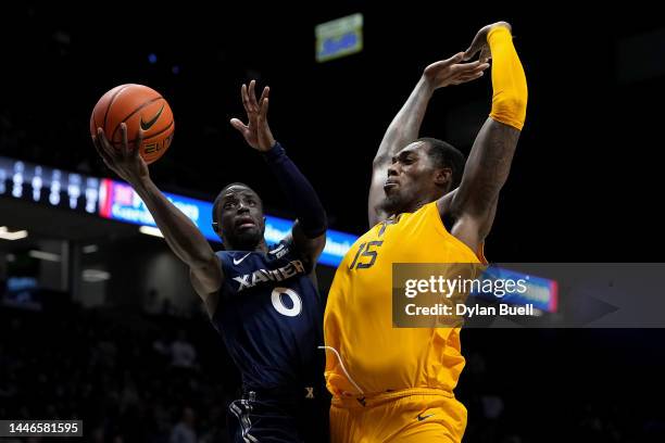 Souley Boum of the Xavier Musketeers attempts a layup against Jimmy Bell Jr. #15 of the West Virginia Mountaineers in the second half of the game at...