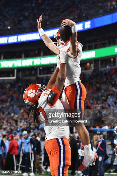 Mitchell Mayes lifts up Cade Klubnik of the Clemson Tigers after Klubnik's second quarter touchdown against the North Carolina Tar Heels during the...