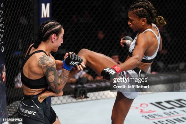 Angela Hill kicks Emily Ducote in a strawweight fight during the UFC Fight Night event at Amway Center on December 03, 2022 in Orlando, Florida.