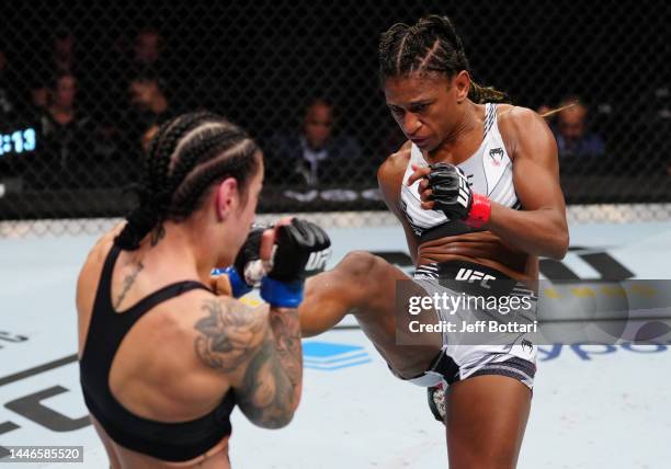 Angela Hill kicks Emily Ducote in a strawweight fight during the UFC Fight Night event at Amway Center on December 03, 2022 in Orlando, Florida.