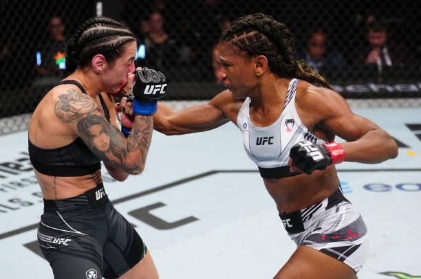 Angela Hill punches Emily Ducote in a strawweight fight during the UFC Fight Night event at Amway Center on December 03, 2022 in Orlando, Florida.
