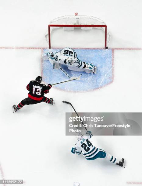 Alex DeBrincat of the Ottawa Senators shot hits the post as Kaapo Kahkonen of the San Jose Sharks and Jaycob Megna look on during the first period of...