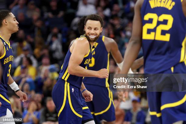 Stephen Curry of the Golden State Warriors smiles as he walks back to the bench during the fourth quarter of their game against the Houston Rockets...