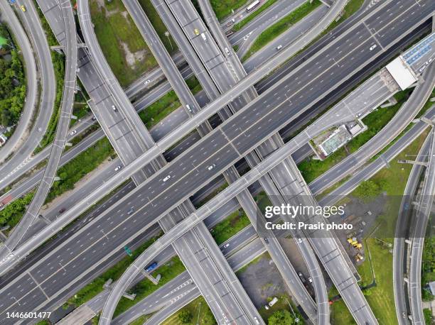 aerial view of modern transportation with expressway, road and overpass, multilevel junction highway-top view. car movement at day important infrastructure. - car aerial view stock pictures, royalty-free photos & images