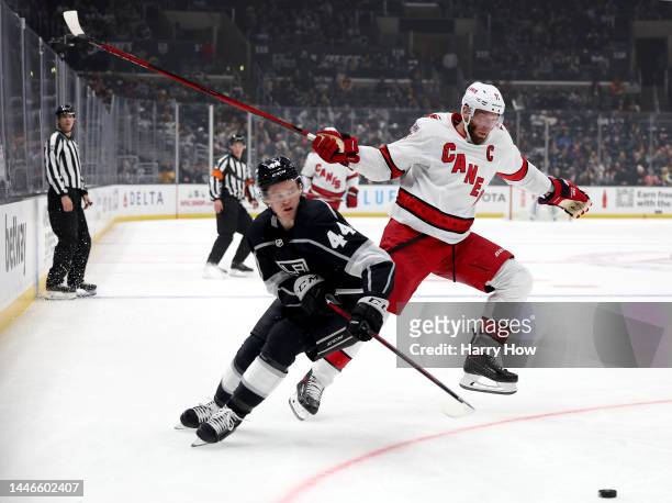Jordan Staal of the Carolina Hurricanes attempts to jump around the check of Mikey Anderson of the Los Angeles Kings during the first period at...