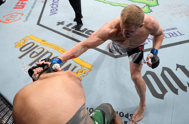 Sergei Pavlovich of Russia punches Tai Tuivasa of Australia in a heavyweight fight during the UFC Fight Night event at Amway Center on December 03,...