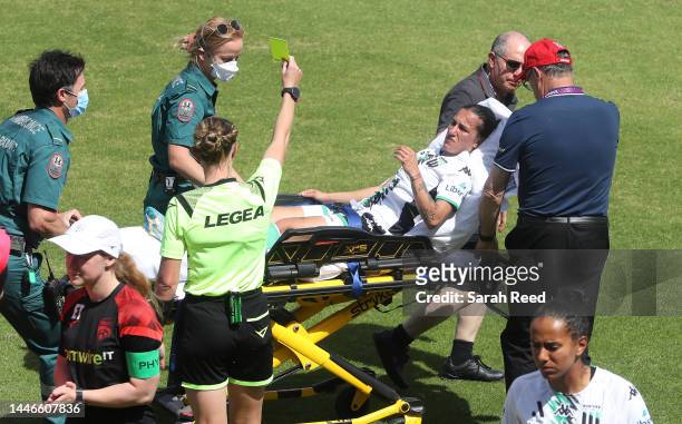 Referee gives a yellow card to Stacey Papadopoulos of Western United on a stretcher after being knocked unconscious during the round 3 A-League...