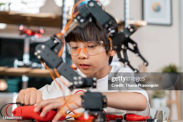 asian boy building robot toy for school science project - robotics alive stock pictures, royalty-free photos & images