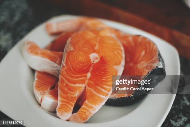 salmon on frying pan - omega 3 fish stock pictures, royalty-free photos & images